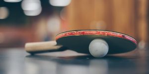 selective focus photo of table tennis ball and ping pong racket